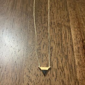 Brand new Uncommon James black and gold triangle necklace.